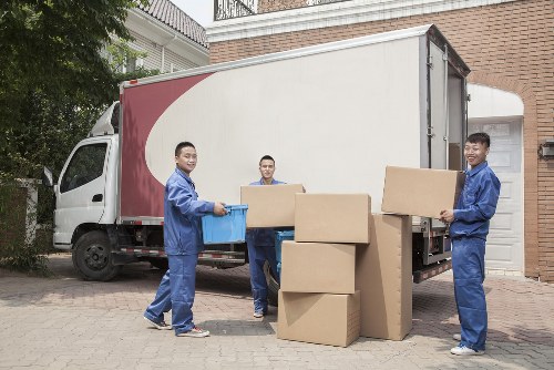 A local removals van loading belongings near Nine Elms residential properties