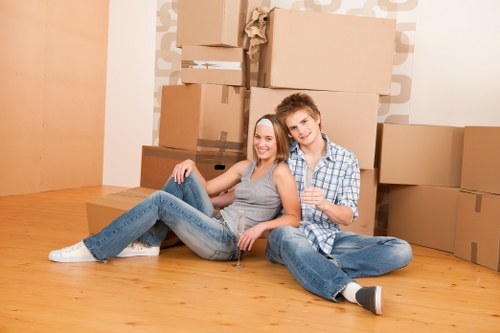 Local movers carrying boxes in a Nine Elms residential development