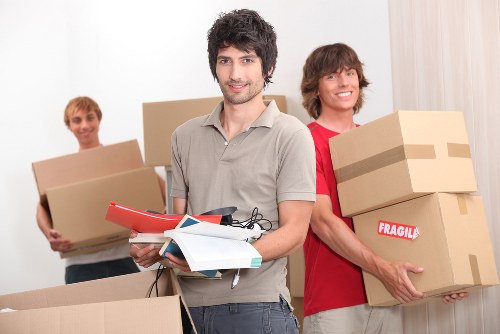 Moving crew handling boxes safely during a house move