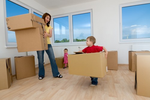 Man with van moving boxes in Nine Elms near modern apartment buildings